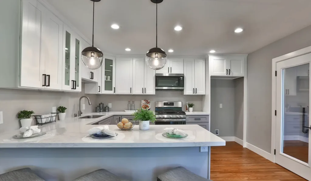 A modern, stylish kitchen with white cabinetry and sleek design. Ready to transform your kitchen? Hire a professional contractor to ensure your remodel is completed perfectly from start to finish!