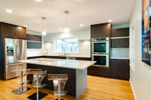 Modern 12x12 kitchen remodel with sleek finishes and ample lighting. Discover the benefits of hiring a professional contractor to elevate your kitchen renovation.